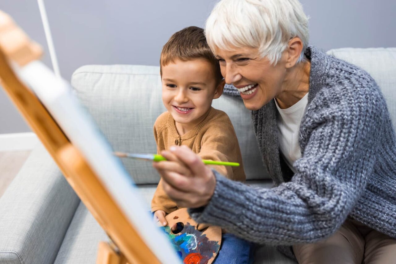 elderly person painting with child