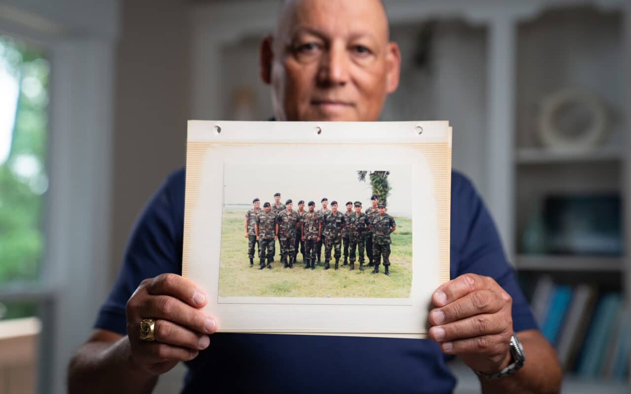 Veteran holds up image of time in service