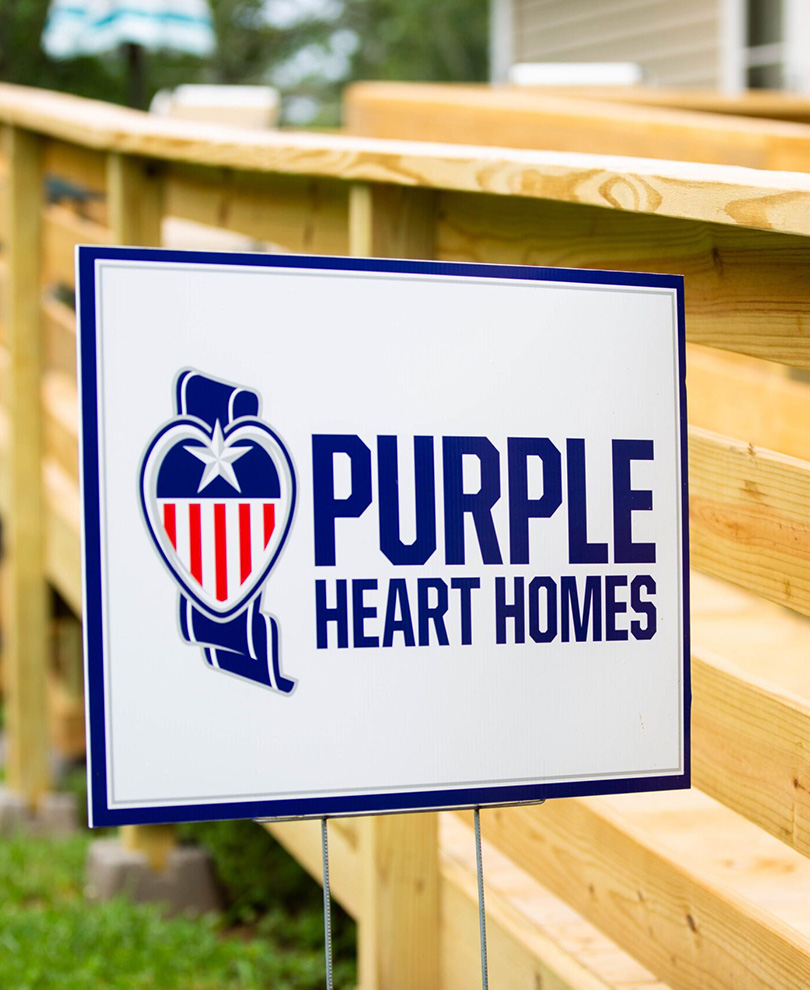 Purple Heart Homes Sign in front of porch